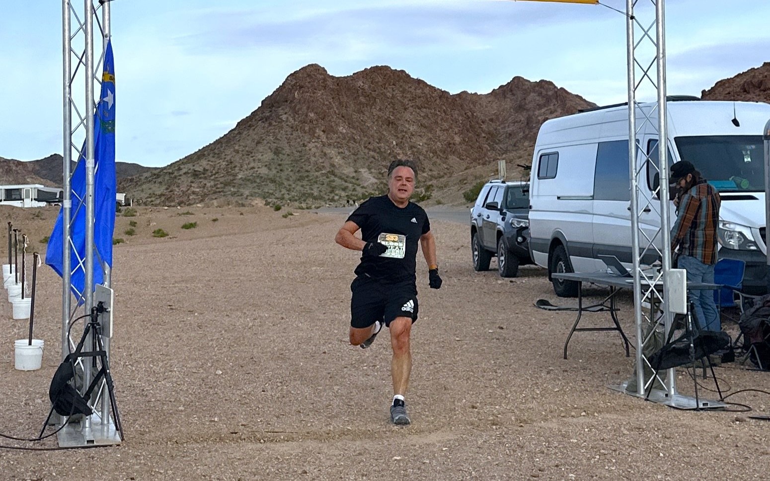 Curtis running through a START arch at an early race in the desert