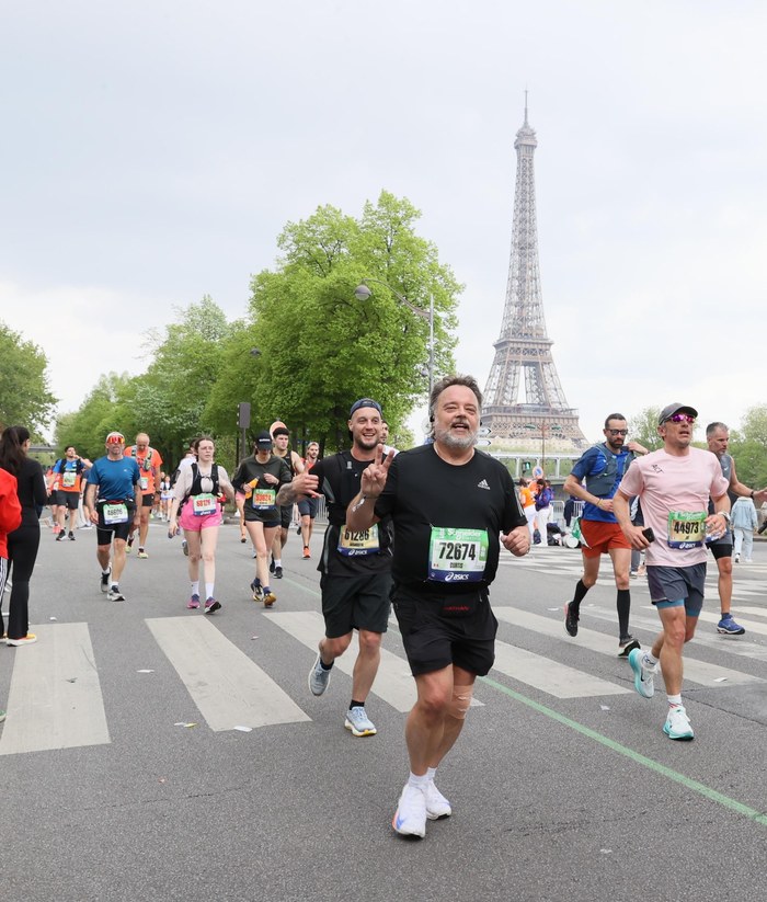 Curtis running past the Eiffel Tower in the Paris Marathon