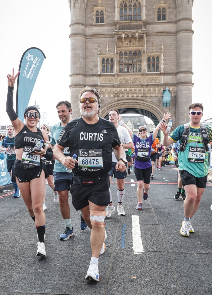 Curtis running past Tower Bridge in the London Marathon