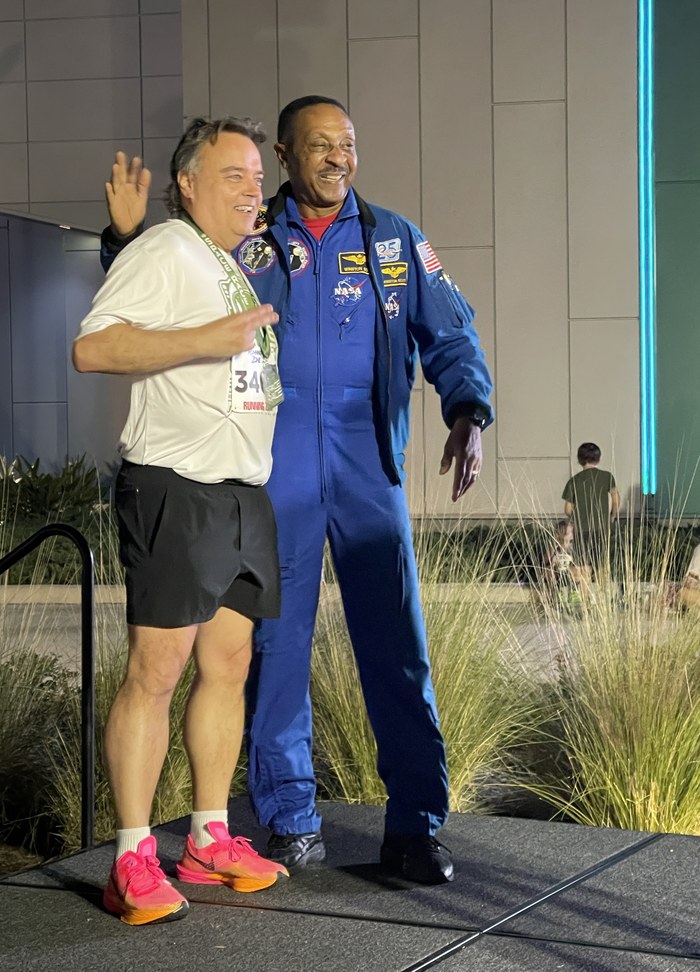 Curtis posing with an astronaut at the NASA Kennedy Space Center race
